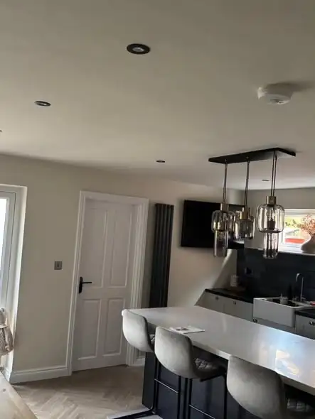 Open-plan kitchen in Fenny Drayton with cream walls and white doors, freshly decorated