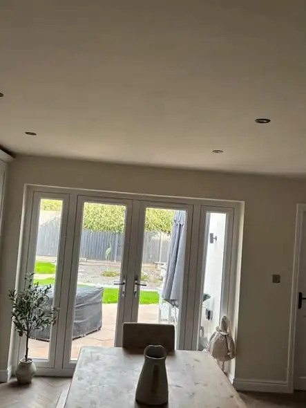 Newly plastered and painted dining area with French doors to the garden