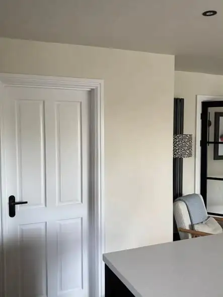 White four-panel door and cream walls after decorating